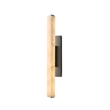 The Selvara LED Medium Alabaster Wall Light in Matte Black & Soft White features a vertical, cylindrical shade and rectangular backplate, offering striking modern accent lighting against a white background.