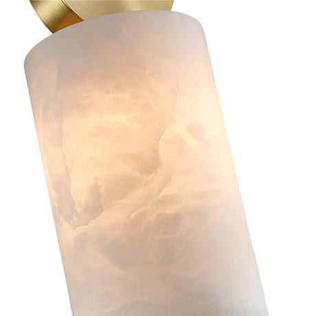 The Serano 1 Light Large Vertical Pillar Alabaster Single Pendant Light in Soft White & Brass features a frosted alabaster shade with a brass accent, emitting a warm, diffused glow through its textured glass.