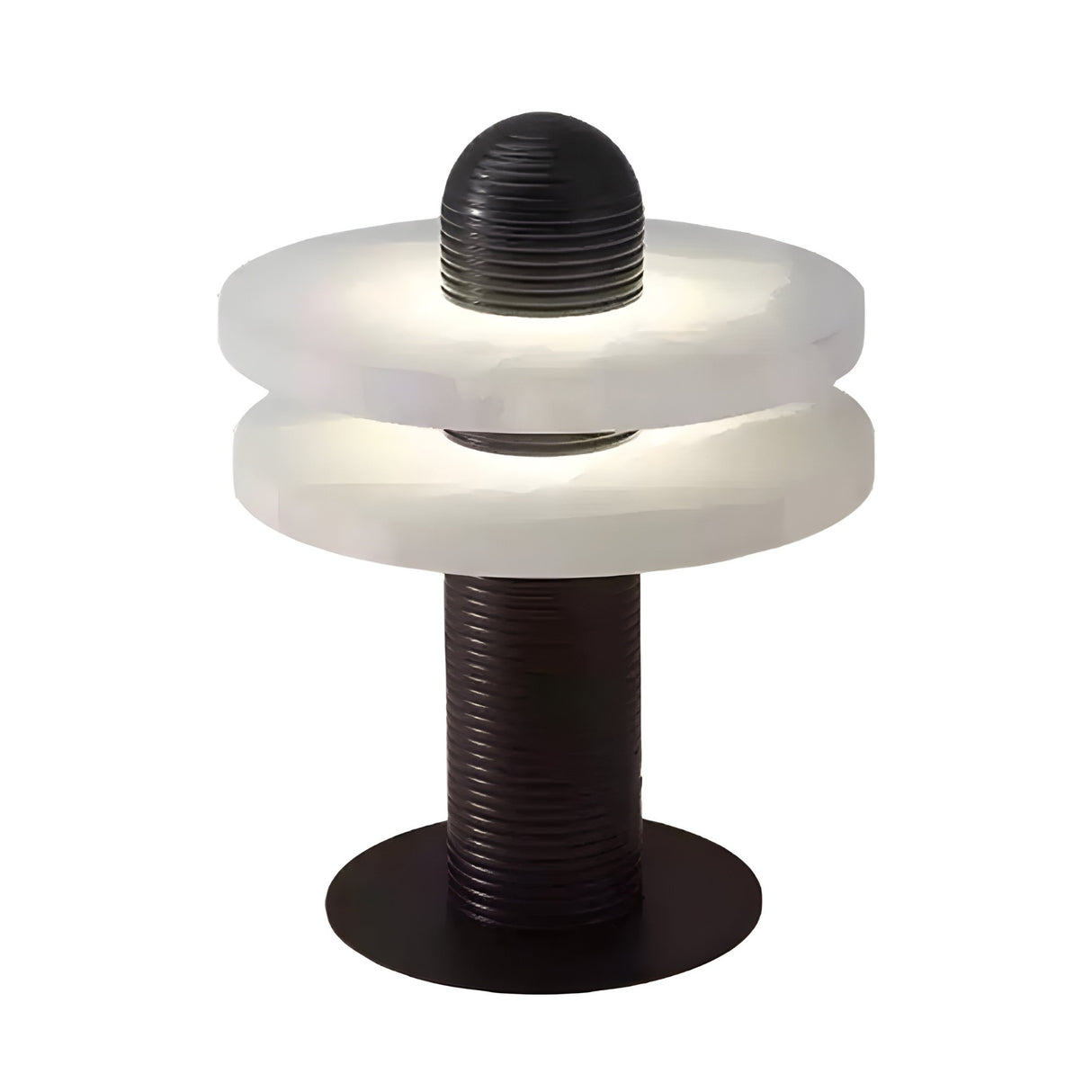 The Nyxara LED Double Tiered Alabaster Table Lamp features a cylindrical black base, two frosted white rings separated by a gap, and a grooved black column. Lit in soft white and black, it creates a modern, glowing ambiance.