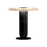 The Luxelle LED Single Tiered Alabaster Table Lamp in soft white and brass features a modern cylindrical base and a wide, flat, circular frosted white shade, shown against a plain white background.