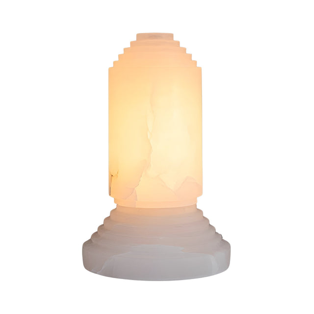 The Lumorin 1 Light Sculpted Alabaster Table Lamp - Soft White features a cylindrical design with stepped geometric details, crafted from natural Spanish alabaster, emitting a warm glow, and shown against a plain white background.