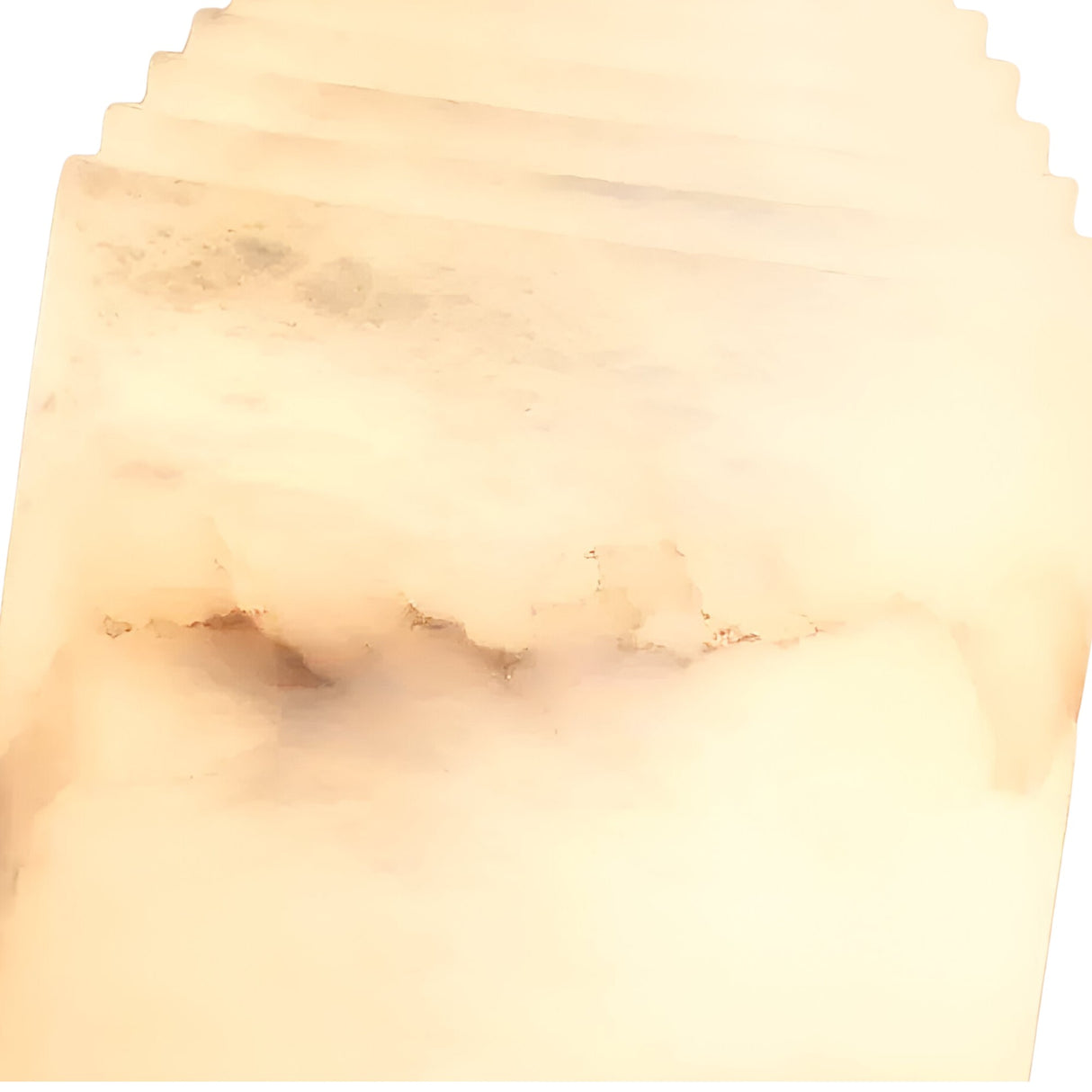 A close-up of the Lumorin 1 Light Sculpted Alabaster Table Lamp—Soft White reveals translucent, cream-toned Spanish alabaster with subtle brown and gray veining, creating its smooth, layered look.