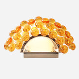 Introducing the Briller LED Small Wall Light - Gold, featuring a semi-circular base and an artistic fan-like display of amber acrylic spheres that exudes modern elegance in a stunning gold finish.