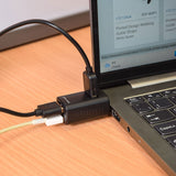 AV:Link 3 Port Mini USB-C Hub in matt black plugged into a laptop with USB-A cables connected, shown on a wooden desk.