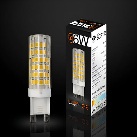 Schuller G9 LED capsule bulb, 6W 3000K warm white, shown beside its black and white printed retail box on a dark reflective background.