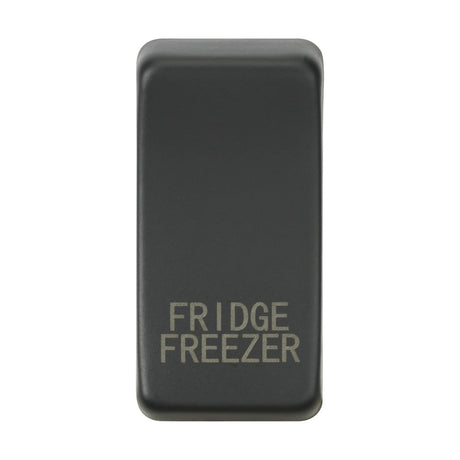 The Switch Cover "Marked FRIDGE FREEZER" - Anthracite is a rectangular black accessory with an anthracite finish that has the words "FRIDGE FREEZER" in capital letters on its smooth surface. It features rounded edges and a minimalist design, highlighting elegance and simplicity.