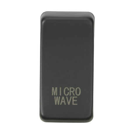 A sleek black rectangular button with the word "MICROWAVE" engraved in silver lettering sits on a plain white background. Its interchangeable design adds versatility, making it the anthracite gem of your kitchen controls, known as the Switch Cover "Marked MICROWAVE.