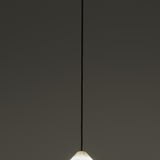 Fuji LED Alabaster Dimmable Pendant Light in Polished Brass, showing the cone-shaped alabaster shade glowing softly on a slim black flex against a plain grey background.