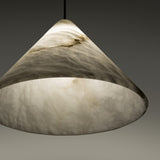 Fuji LED alabaster pendant light, cone-shaped shade with grey veining glowing softly, hung on black flex against a neutral grey background.
