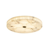 The Veltrix LED Medium Round Alabaster Flush Ceiling Light in soft white and brushed brass blends modern style with a central hole for an elegant, contemporary look.