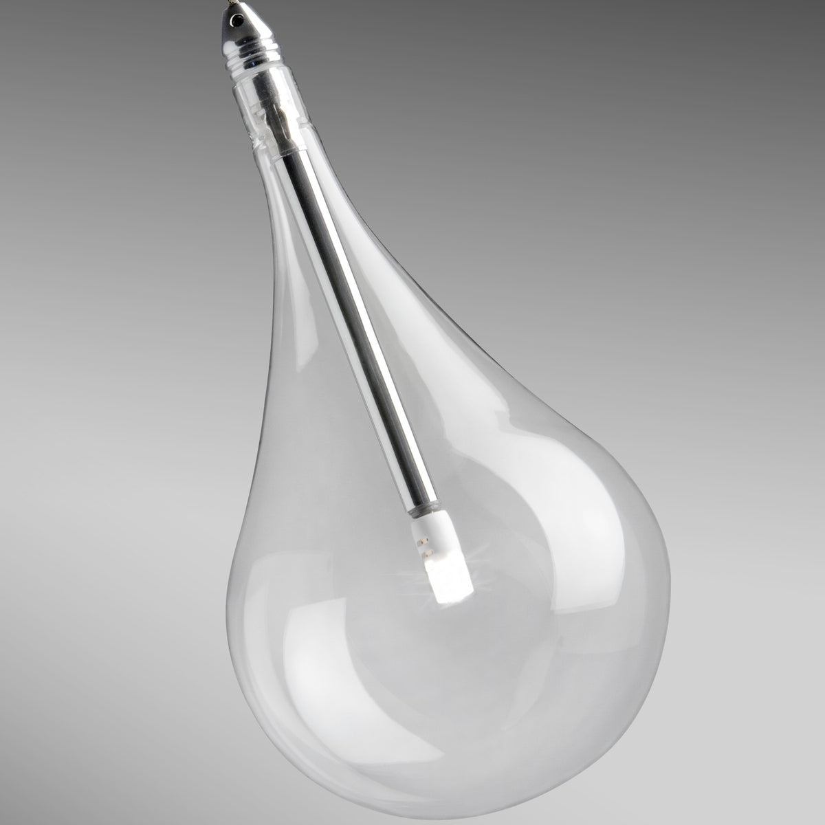 Yarvelle pendant light detail showing a clear glass teardrop shade with internal chrome tube and LED, photographed against a plain grey background.