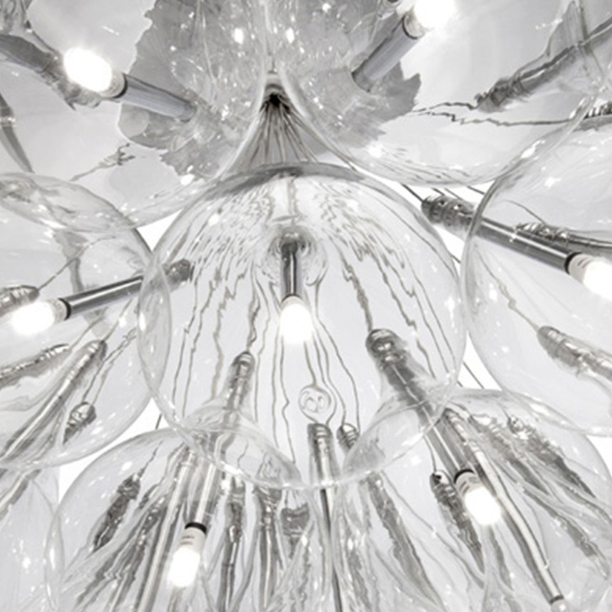 Close-up of the Yarvelle 37 Light Glass Pendant Light in chrome, showing clustered clear glass teardrop shades with slim internal chrome tubes and bulbs on fine cables.