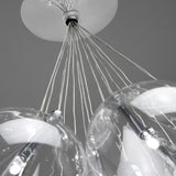 Close-up of the Yarvelle glass pendant light showing clear teardrop globes with chrome holders suspended on multiple cables from a white ceiling rose.