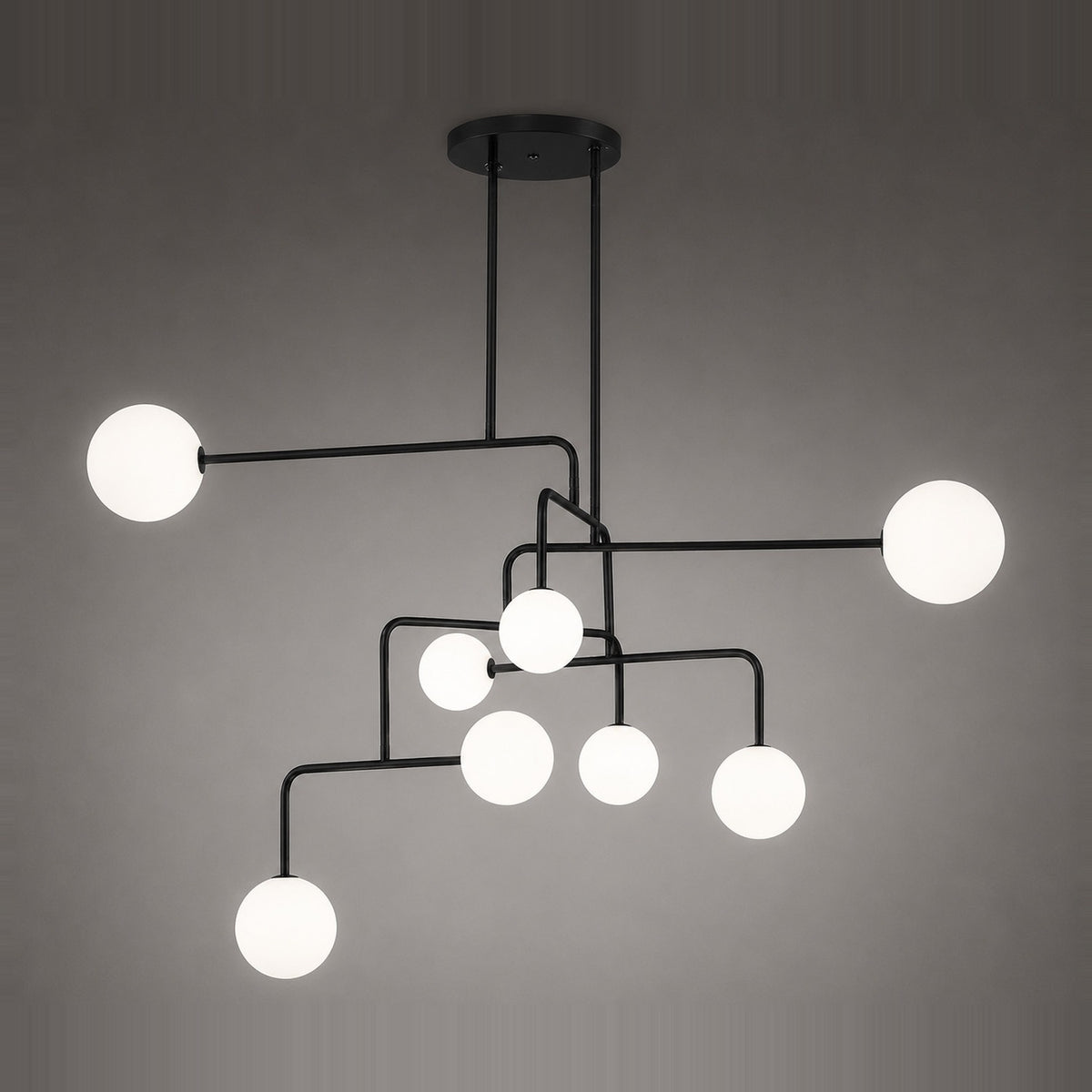 Lumorne 8-Light Glass Globe Chandelier with textured black metal rods branching asymmetrically from a round ceiling plate, each ending in a different-sized opal glass globe.