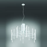 TheLight LED 18 Light Chandelier in white, with radiating arms and glowing vertical rods around a fluted central cylinder, suspended against a plain grey background.