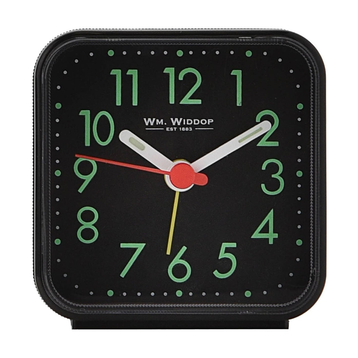 Square black plastic alarm clock with luminous dial, green Arabic numerals, white hour and minute hands, red and yellow accent hands, on a plain white background.
