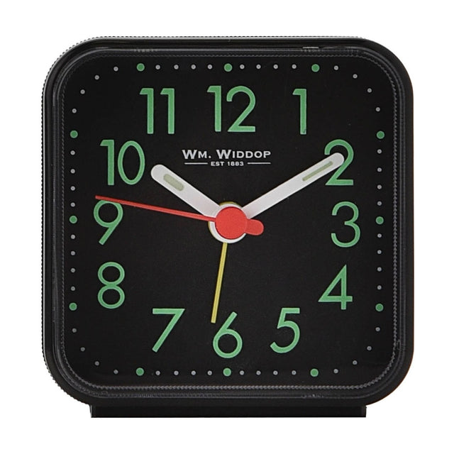 Square black plastic alarm clock with luminous dial, green Arabic numerals, white hour and minute hands, red and yellow accent hands, on a plain white background.