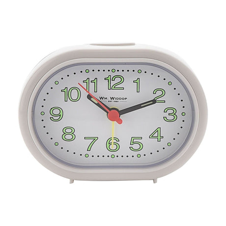 Oval white plastic alarm clock with analogue dial, luminous green Arabic numerals, black hour and minute hands, red second hand, and minute dot markers, shown on a plain white background.