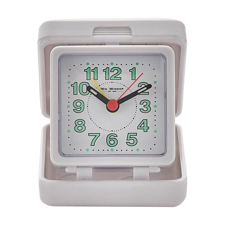 Square folding quartz travel alarm clock in white plastic, open on its hinged base with pale green Arabic numerals, black hands, and red and yellow centre hands, shown on a plain white background.