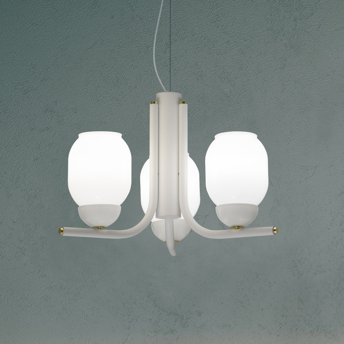 Faronne 3 Light Glass Chandelier in white, three opal glass barrel shades on curved iron arms with brass accents, shown against a muted teal background.