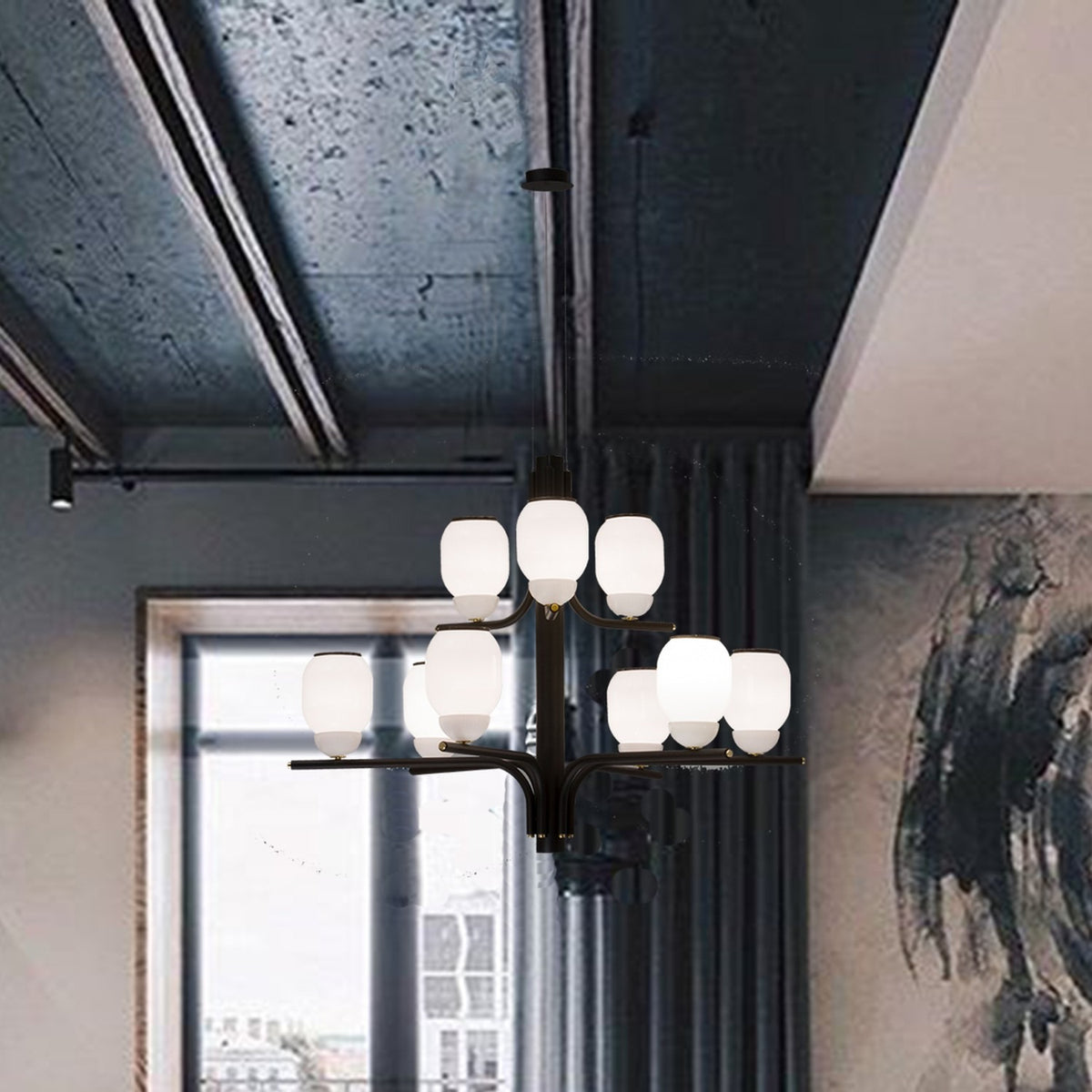 Faronne 9 Light Glass Chandelier in black, with opal glass barrel shades in two tiers on sweeping arms, shown suspended in a room with dark ceiling beams.