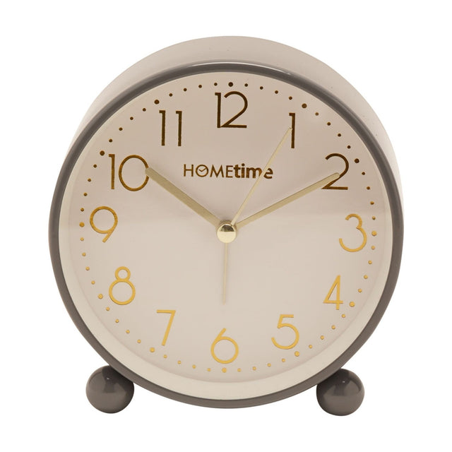 Round metal case alarm clock in glossy grey with a cream dial, gold Arabic numerals and hands, set on two round feet, shown on a plain white background.