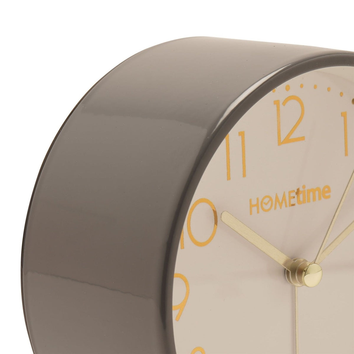 Close-up of the round Metal Case Alarm Clock in glossy grey, showing the cream dial with gold Arabic numerals, minute dots, and slim gold hands.