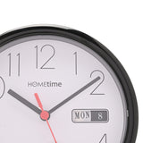 Close-up of a round black and white wall clock with gloss black plastic case, white dial, bold Arabic numerals, black hands, red second hand, and a day/date window showing "MON 8".