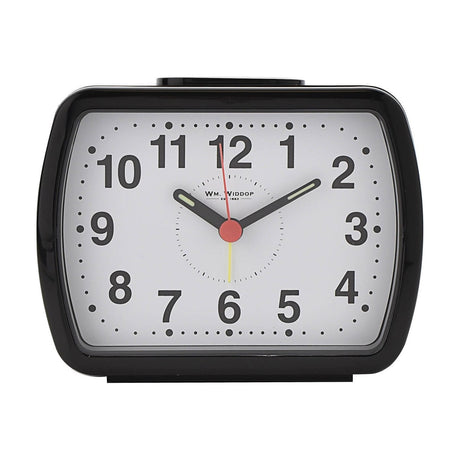 Oblong black plastic alarm clock with rounded corners, white dial, bold black Arabic numerals, luminous hour and minute hands, red centre dial, shown on a plain white background.