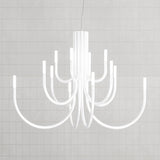 ThePalm LED 12 Light Chandelier in white, with slender curved arms rising from a fluted central stem to glowing acrylic tips, shown against a plain light grey background.