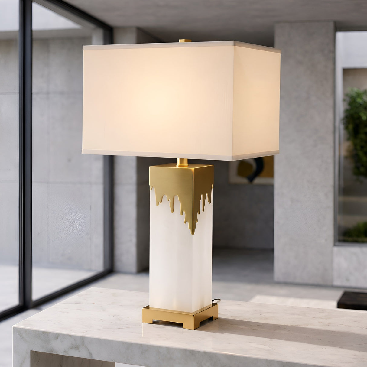 The Lumixia 1 Light Gilded Edge Alabaster Table Lamp in Brass & Soft White features a sculptural square base, rectangular white shade, and gold accents, perfect for adding modern elegance to any contemporary space.