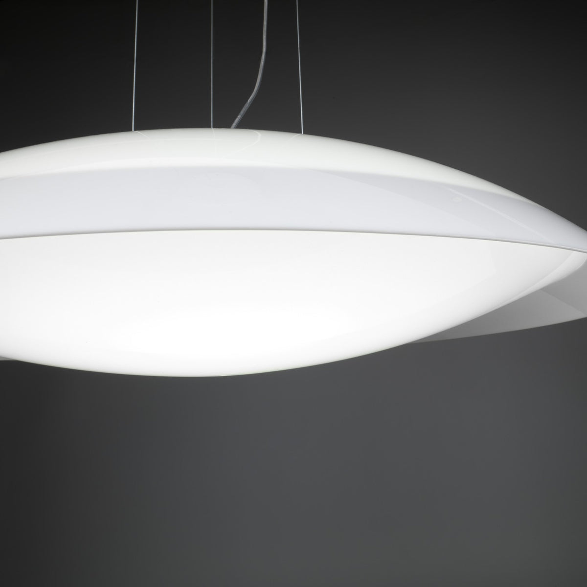 Lens LED Pendant Light in white, a wide shallow domed disc with a curved opal acrylic diffuser and tapered rim, shown against a dark grey background.