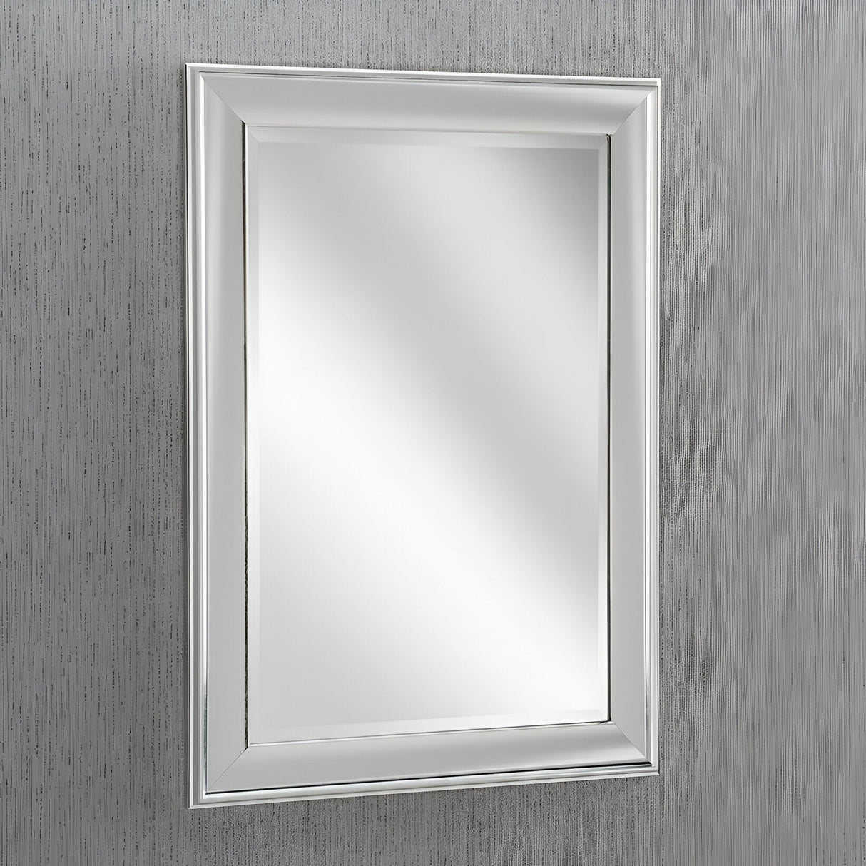 The Pulse Rectangle Wall Mirror - Silver is mounted on a textured gray wall, adding a contemporary touch with its sleek silver frame as it softly reflects light.