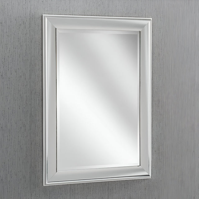 The Pulse Rectangle Wall Mirror - Silver is mounted on a textured gray wall, adding a contemporary touch with its sleek silver frame as it softly reflects light.