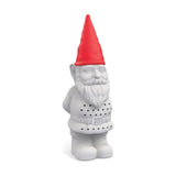 Bearded Garden Gnome tea infuser in grey plastic with a red pointed hat, belted coat perforated with small holes, hands behind his back, on a plain white background.