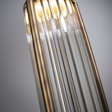 Close-up of the Kalvenne LED glass pendant light, showing ribbed glass rods in a satin bronze iron frame with warm integrated LED illumination, against a grey background.