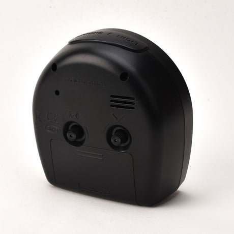 Rear view of the Arched Plastic Alarm Clock in black, showing light/snooze button, speaker vents, adjustment dials, and battery compartment on a plain white background.