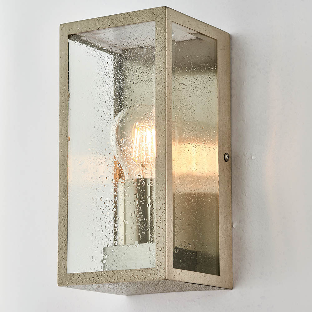 Endon Castwick silver box lantern wall light with bevelled glass panels and a single E27 filament bulb, mounted on a plain white wall.