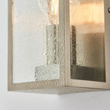 Close-up of Endon Castwick Lantern Wall Light in silver, showing the brushed steel box frame and water-speckled bevelled glass panels with a warm glow.