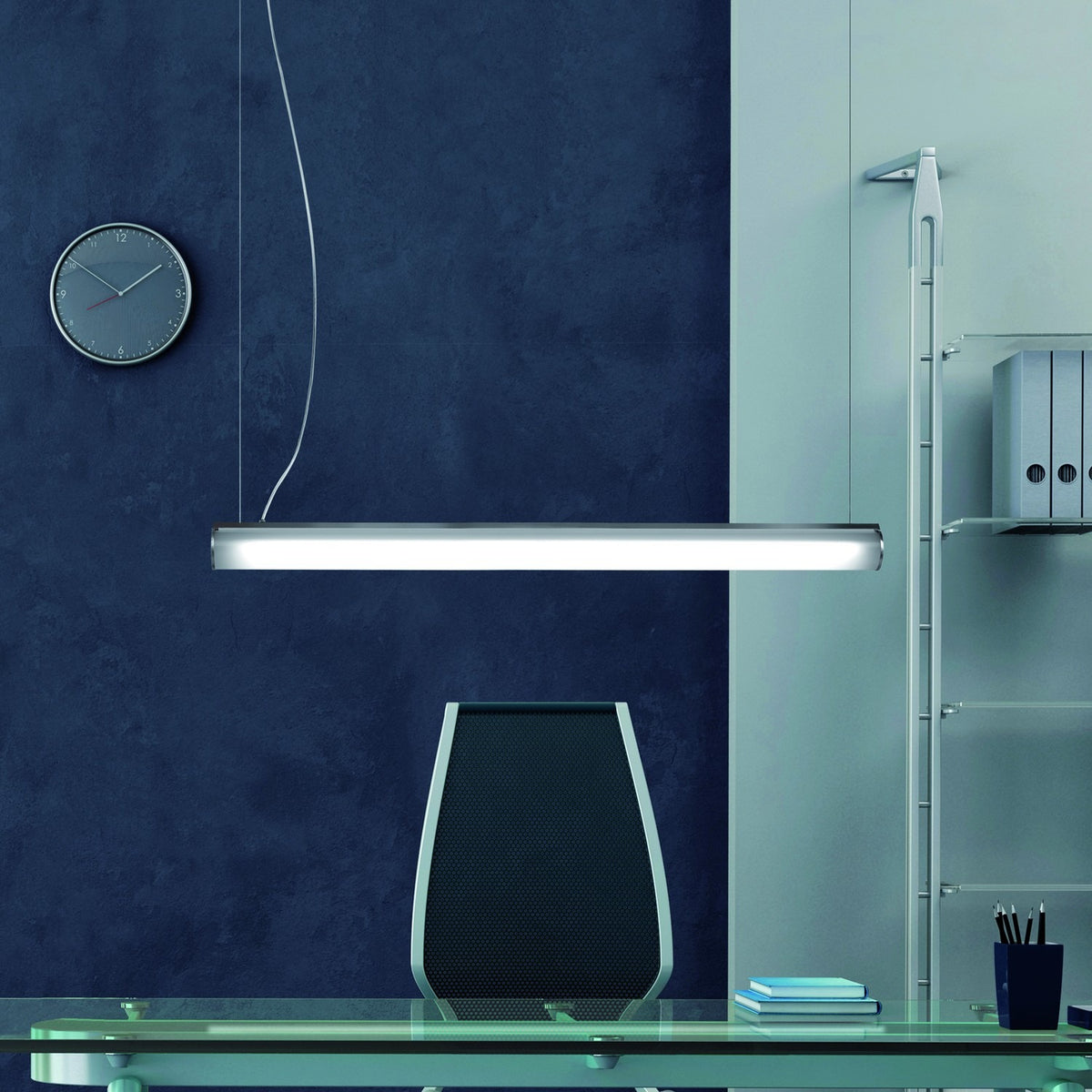Bath A LED Linear Pendant Light in white, a slim tube-shaped fixture with polycarbonate diffuser, suspended above a desk in an office setting.