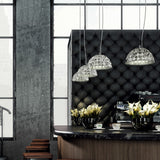 Deco Crystal Pendant Light in chrome, dome-shaped faceted crystal shades on slim cables above a tufted black banquette in a café setting.