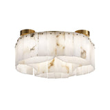 The Elara 10 Light Layer Panel Alabaster Ceiling Semi-Flush Light features soft white rectangular alabaster panels with subtle brown veining on a round brass base, offering a modern, elegant glow.