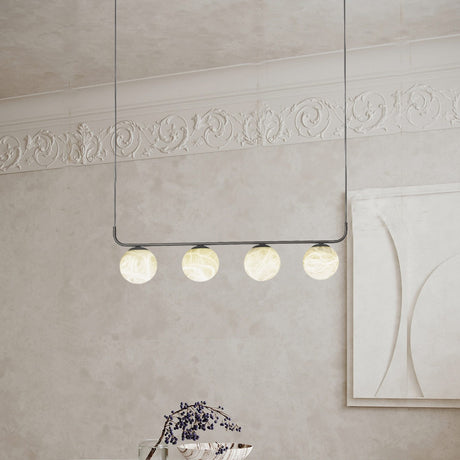 Halvessa LED 4 Light Alabaster Pendant Light in black, four glowing alabaster globes on a slim horizontal bar, shown hanging in a room with ornate cornicing.