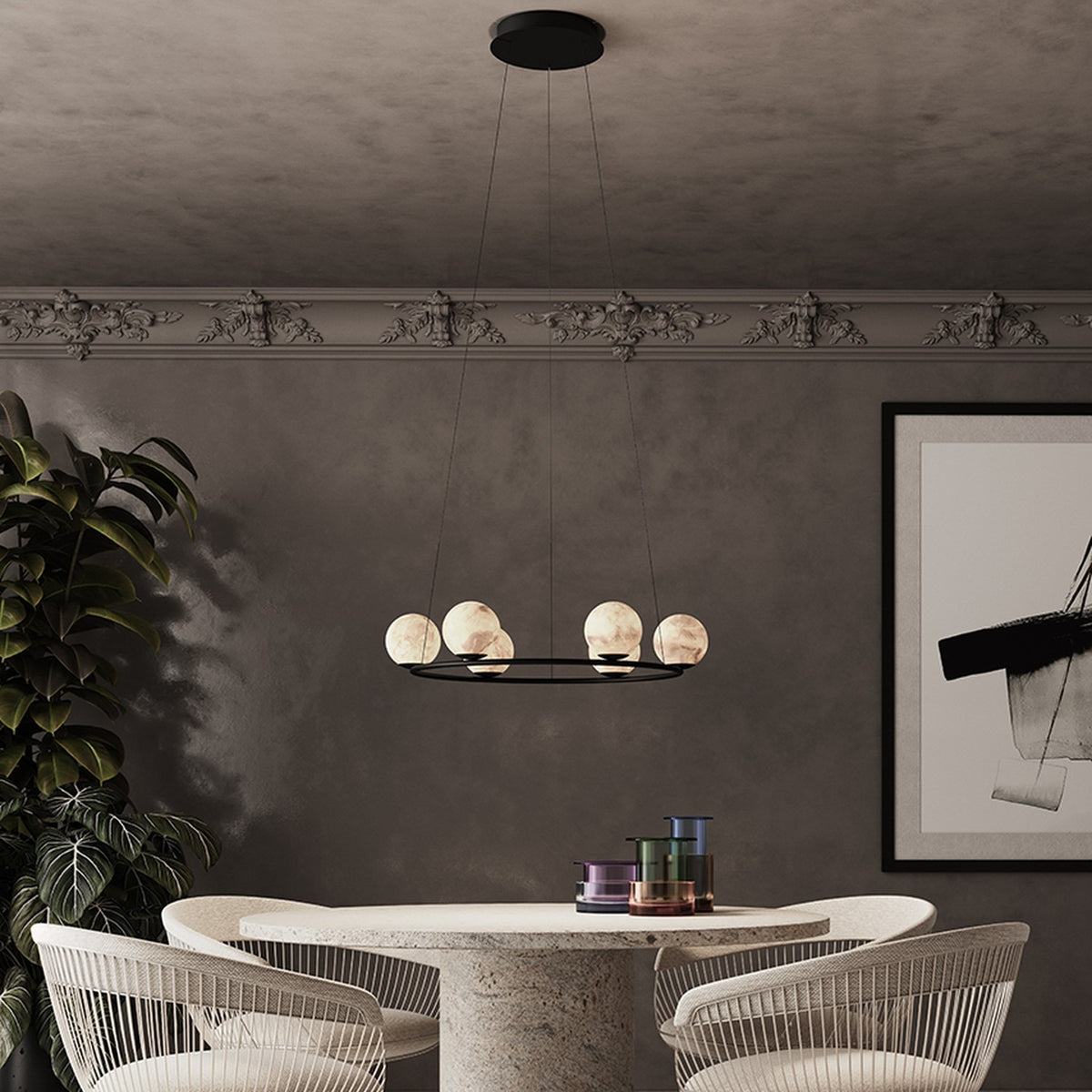 Halvessa LED 6 Light Alabaster Chandelier in black, round ring design with glowing alabaster globes, shown above a dining table in a neutral-toned room.