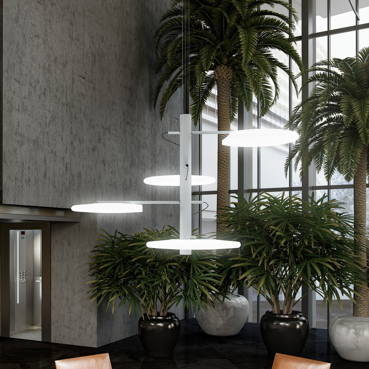 SuperMoon LED 4 Light Pendant Light in white, with a central stem and staggered round crescent-cut discs, shown illuminated above indoor plants in a lobby setting.