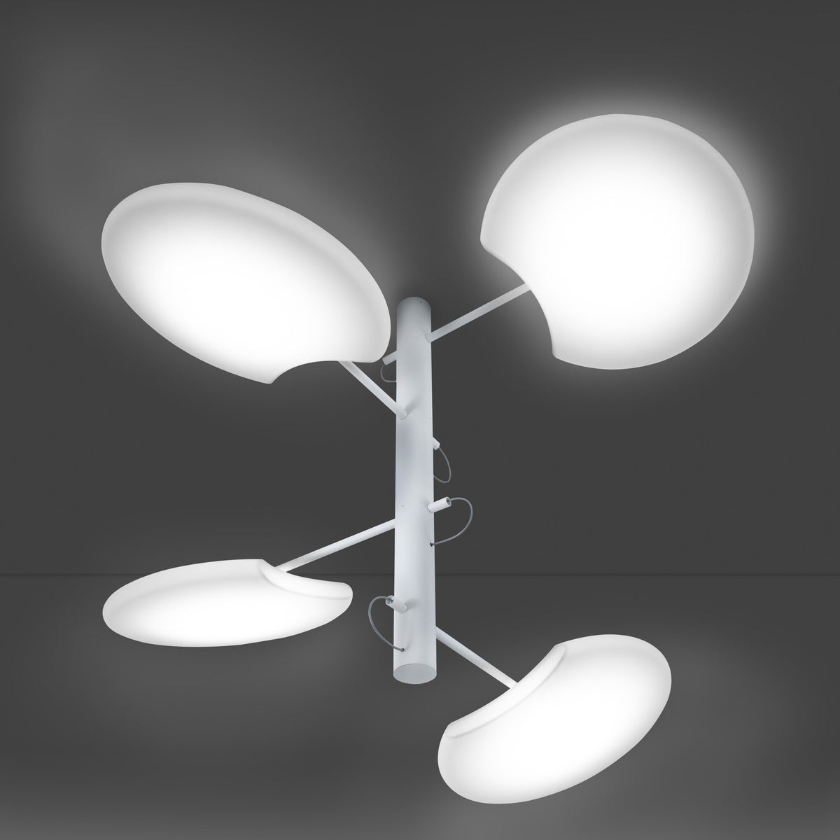 SuperMoon LED 4 Light Pendant Light in white, with a slim vertical stem and four staggered arms holding round crescent-cut disc shades, shown illuminated against a dark background.