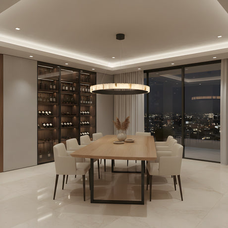 A modern dining room featuring a wooden table, eight white upholstered chairs, a Lucenza LED Small Halo Ring Alabaster Chandelier in matte black & soft white, a wall-mounted wine rack, and floor-to-ceiling windows with city night views.