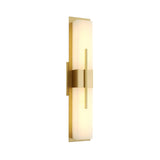 The Caldera LED Large Floating-Band Alabaster Wall Light features a vertical rectangular frosted glass shade framed by brushed brass, emitting a warm glow against a white background.