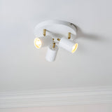 Endon Radnor 3 Light Round Spotlight in matt white with brass fittings and three adjustable GU10 heads, mounted on a pale ceiling with cornice below.