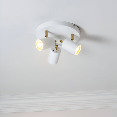 Endon Radnor 3 Light Round Spotlight in matt white with brass fittings and three adjustable GU10 heads, mounted on a pale ceiling with cornice below.